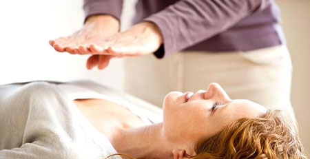 Practitioner 'laying hands' on client